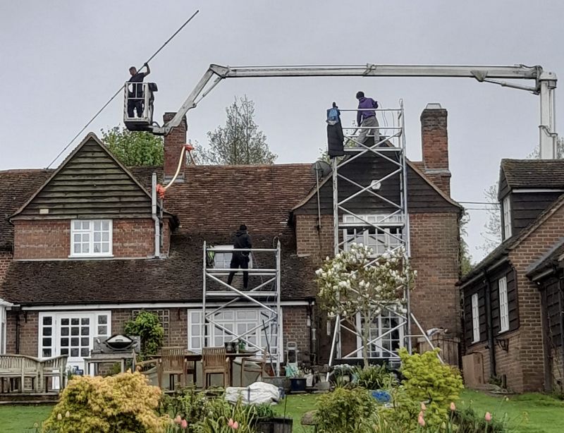 The Roof Moss Cleaners using cherry picker and scaffolding to clean roof safely and professionally in Whitnash, Warwickshire