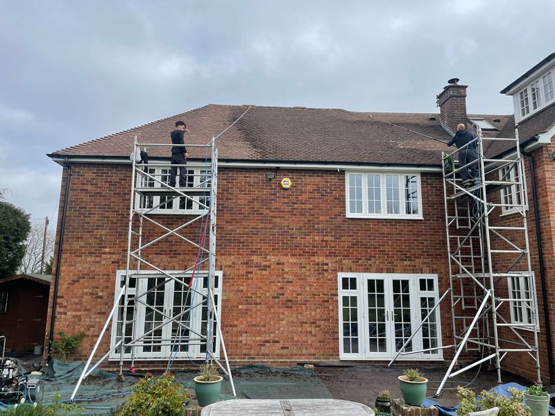 Roof cleaning carried out safely from scaffold towers by The Roof Moss Cleaners in Whitnash